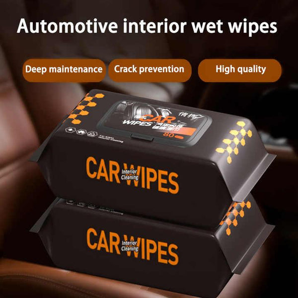 Stacks of black packages labeled Car Interior Cleaning Wipes sitting on a brown leather car seat, highlighting automotive interior wet wipes for deep maintenance and crack prevention